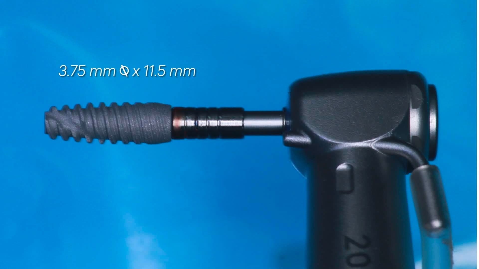 Close-up of the 3.75 x 11.5 mm implant mounted on the delivery driver against a blue photographic backdrop